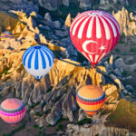 hot-air-balloons-over-mountain-7383a3f718_x1000