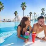 Young couple on infinity pool cocktails